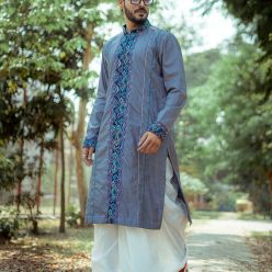 Silk Achkan with printed and embroidered mid-strip, teamed up with off-white embroidered dhoti